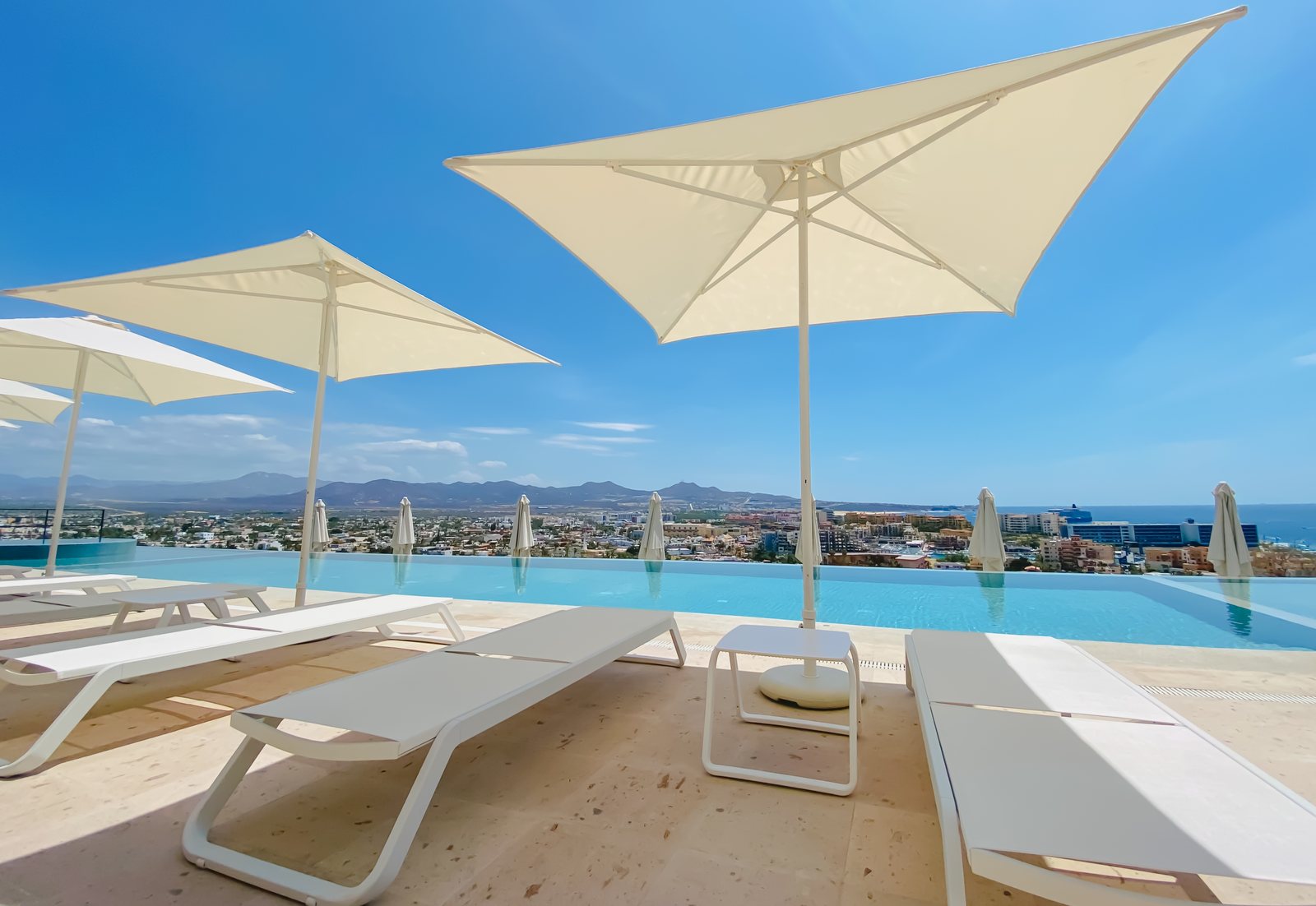 Loungers and umbrellas on the Montemar pool deck above Cabo San Lucas