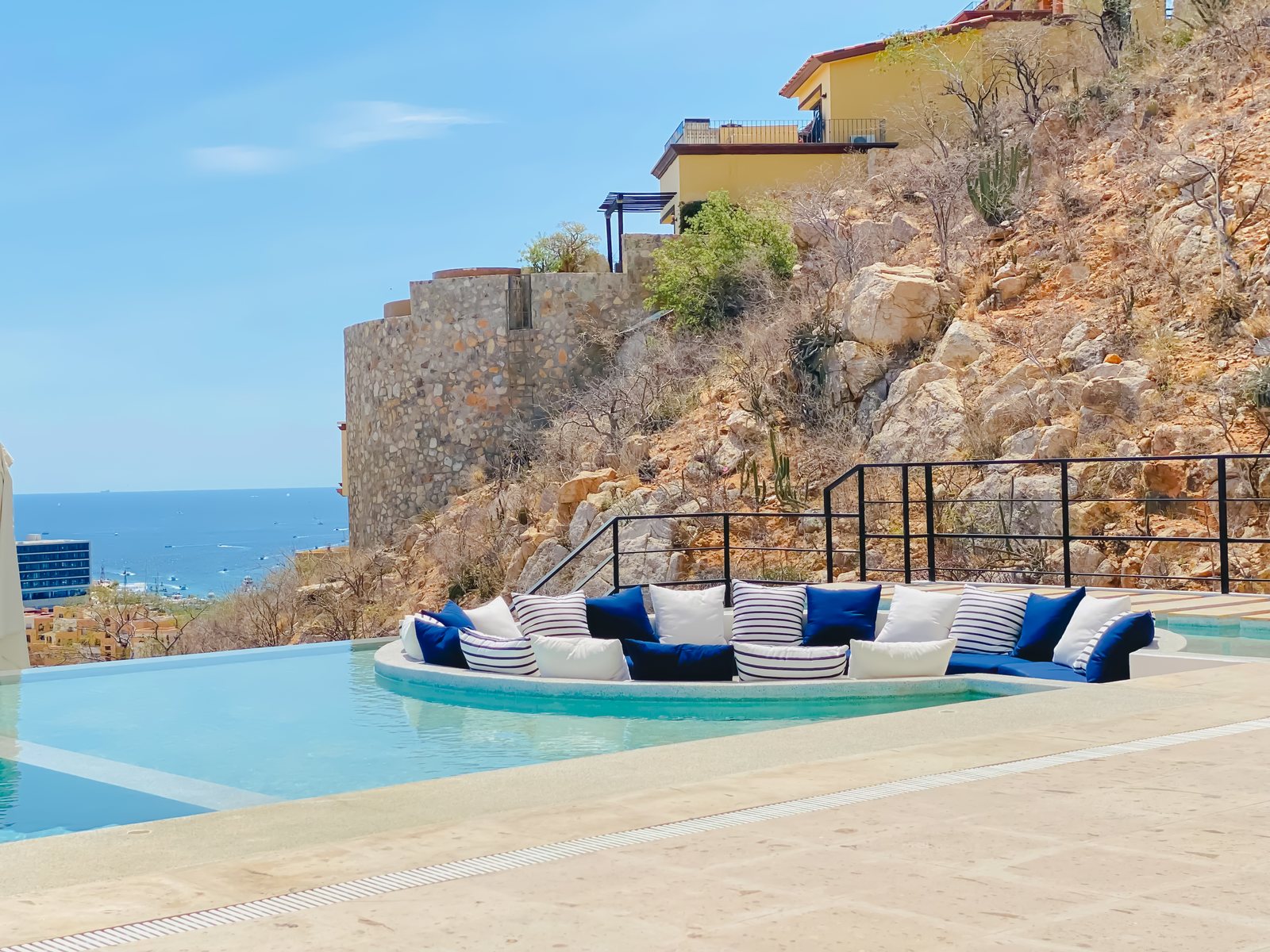 Sunken seating island with cushions set into the Montemar pool